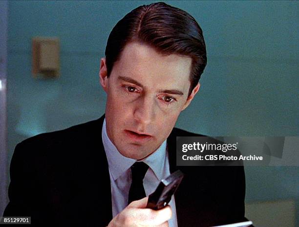 Kyle MacLachlan as Special Agent Dale Cooper hard on the heels of a murderer, from the pilot episode screen grab of the hit television series 'Twin...