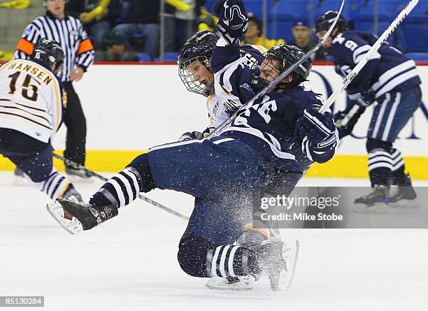 Andrew Meyer of the Quinnipiac Bobcats knocks Sean Backman of the Yale Bulldogs to the ice on February 20, 2009 at the TD Banknorth Sports Complex in...