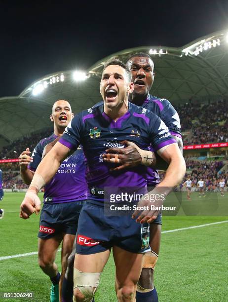 Billy Slater of the Storm is congratulated by Suliasi Vunivalu and his teammates after scoring a try during the NRL Preliminary Final match between...