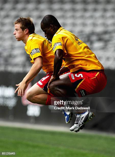Jonas Salley and Scott Jamieson of United warm up during an Adelaide United A-League training session at the Telstra Dome on February 27, 2009 in...