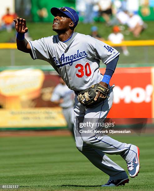 Second baseman Orlando Hudson of the Los Angeles Dodgers looks to catch a pop-up against the San Francisco Giants during a spring training game at...