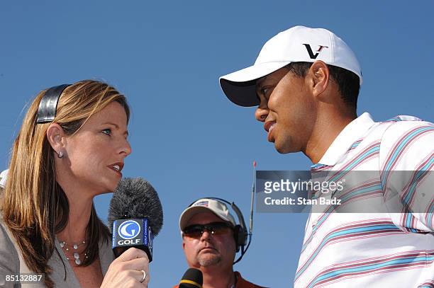 Golf Channel co-anchor Kelly Tilghman, left, interviews Tiger Woods, right, after his defeat to Tim Clark during the second round of the World Golf...