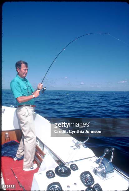 Vice President George Bush tries to catch a fish August 1983 in Kennebunkport, ME. Bush is vacationing in Maine with his family.