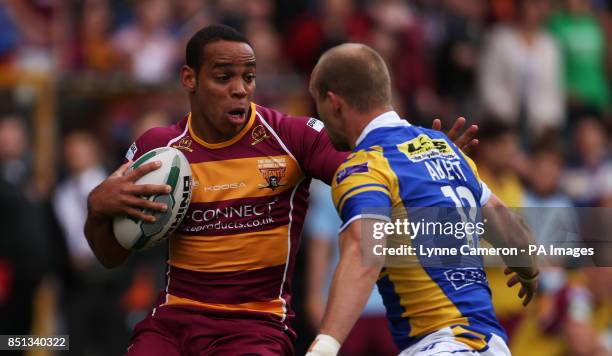 Huddersfield Giants Leroy Cudjoe and Leeds Rhino's Carl Ablett during the Super League match at The Galpharm Stadium, Huddersfield.