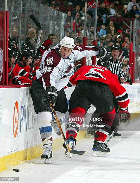 Ryan Smyth of the Colorado Avalanche skates against Colin White of the New Jersey Devils at the Prudential Center February 26, 2009 in Newark, New...