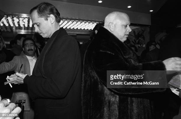 American filmmaker John Waters , and American actor Harris Glen Milstead , better known as Divine , sign autographs for fans outside the Waverly...