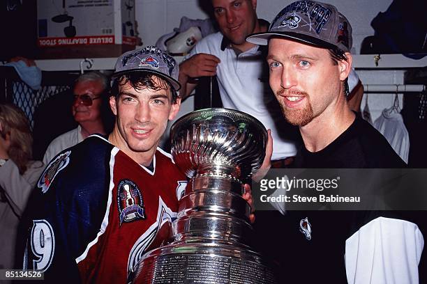 Joe Sakic and Patrick Roy of the Colorado Avalanche poses with the Stanley Cup after beating the Florida Panthers at Miami Areana.