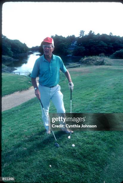 Vice President George Bush holds a golf club August 1983 in Kennebunkport, ME. Bush is vacationing in Maine with his family.