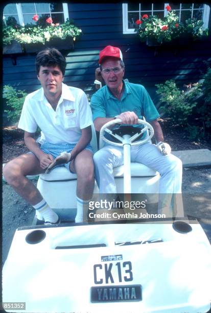 Vice President George Bush drives a golf cart with his son Jeb August 1983 in Kennebunkport, ME. Bush is vacationing in Maine with his family.