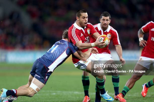 The British & Irish Lions' Sean Maitland is tackled by Melbourne Rebels' Lachlan Mitchell