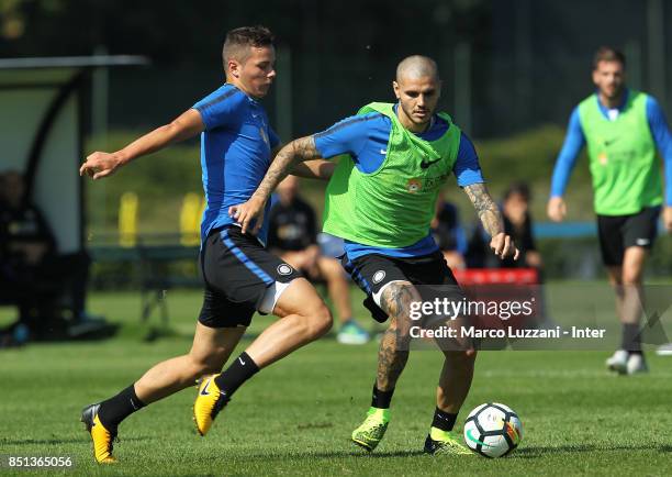 Mauro Emanuel Icardi is challenged by Zinho Vanheusden during the FC Internazionale training session at the club's training ground Suning Training...