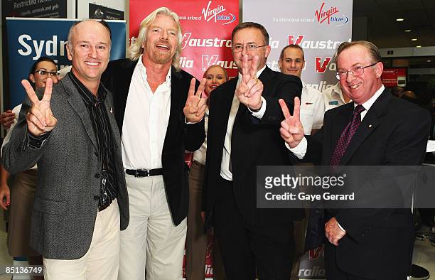 Sir Richard Branson, Brett Godfrey - CEO of Virgin Blue, Anthony Albanese - Minister for Transport and Regional Development, and guest, pose during a...