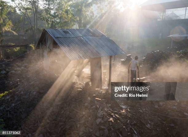 Stone cutters in Selat on the slopes of Mt Agung in Bali going about their usual work on the 19th of September despite a level 3 volcanic alert,...