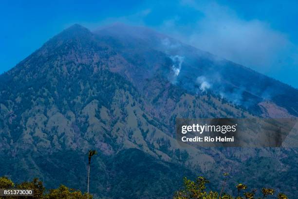 The arid northeastern slopes of Mt Agung in the Kubu district are subject to seasonal brush fires and have recently mistaken for volcanic activity by...