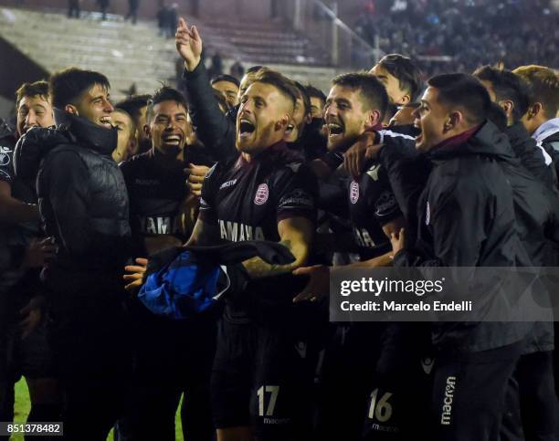 German Denis and Alejandro Silva of Lanus celebrate their qualification to the semifinals after the second leg match between Lanus and San Lorenzo as...