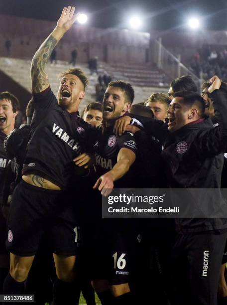 German Denis and Alejandro Silva of Lanus celebrate their qualification to the semifinals after the second leg match between Lanus and San Lorenzo as...