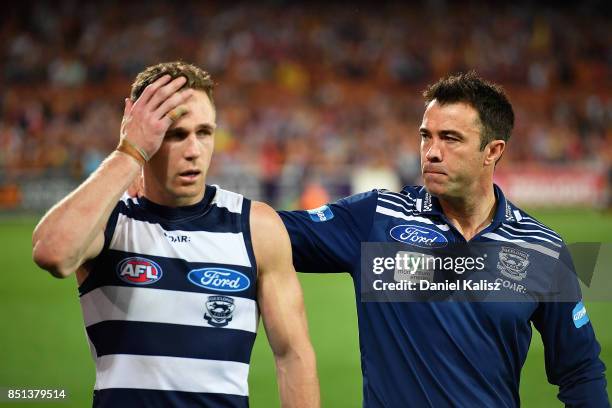 Joel Selwood of the Cats and Cats head coach Chris Scott look on dejected after the First AFL Preliminary Final match between the Adelaide Crows and...