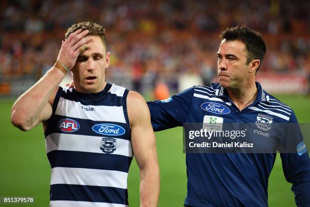 Joel Selwood of the Cats and Cats head coach Chris Scott look on dejected after the First AFL Preliminary Final match between the Adelaide Crows and...