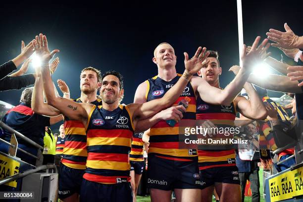 Eddie Betts; Sam Jacobs of the Crows and Taylor Walker of the Crows walk from the field after the First AFL Preliminary Final match between the...