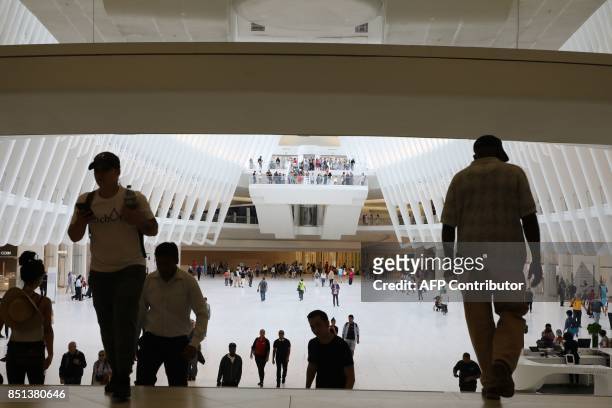 People walk at Westfield World Trade Center Mall on September 21 in New York. / AFP PHOTO / LUDOVIC MARIN