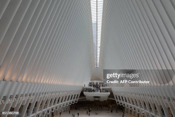 People walk at Westfield World Trade Center Mall on September 21 in New York. / AFP PHOTO / LUDOVIC MARIN