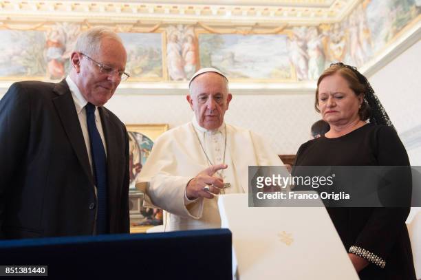 Pope Francis exchanges gifts with President of Peru Pedro Pablo Kuczynski and his wife Nacy Kuczynski during an audience at the Apostolic Palace on...