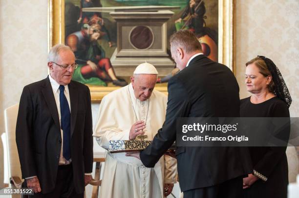 Pope Francis exchanges gifts with President of Peru Pedro Pablo Kuczynski and his wife Nacy Kuczynski during an audience at the Apostolic Palace on...