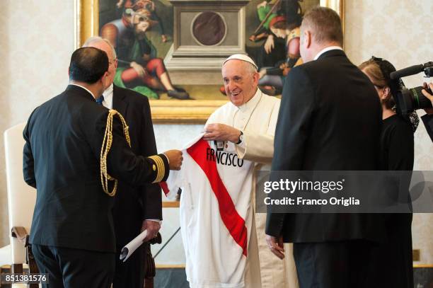 Pope Francis exchanges gifts with President of Peru Pedro Pablo Kuczynski and his wife Nacy Kuczynski during an audience at the Apostolic Palace on...