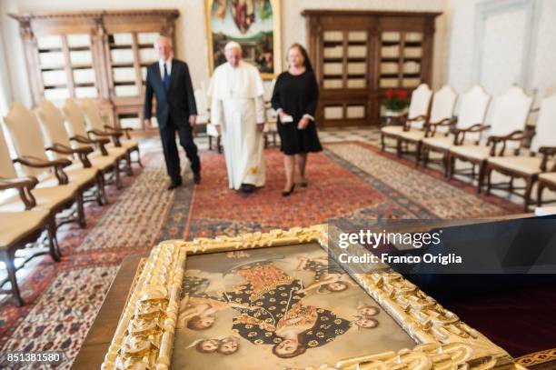 Pope Francis exchanges gifts with President of Peru Pedro Pablo Kuczynski and his wife Nacy Kuczynski during an audience at the Apostolic Palace on...