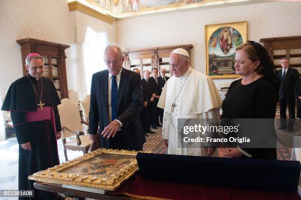 Pope Francis exchanges gifts with President of Peru Pedro Pablo Kuczynski and his wife Nacy Kuczynski during an audience at the Apostolic Palace on...