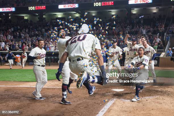 Eddie Rosario of the Minnesota Twins celebrates a walk-off home run with teammates as Kennys Vargas and Ehire Adrianza dump bubble gum against the...