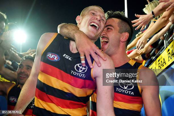 Sam Jacobs and Taylor Walker of the Crows celebrate after the First AFL Preliminary Final match between the Adelaide Crows and the Geelong Cats at...