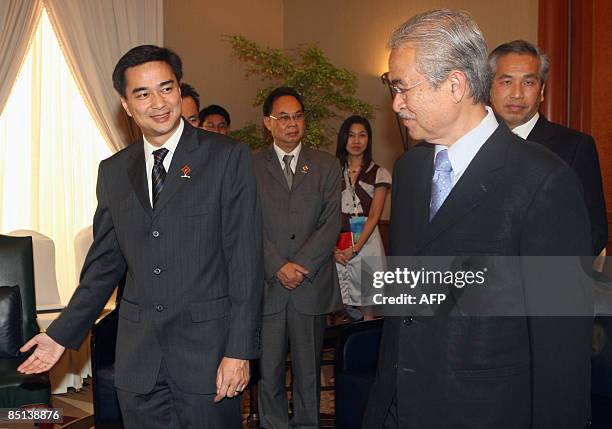 Thai Prime Minister Abhisit Vejjajiva shows the way to his Malaysian counterpart Prime Minister Abdullah Ahmad Badawi during a bilateral meeting of...