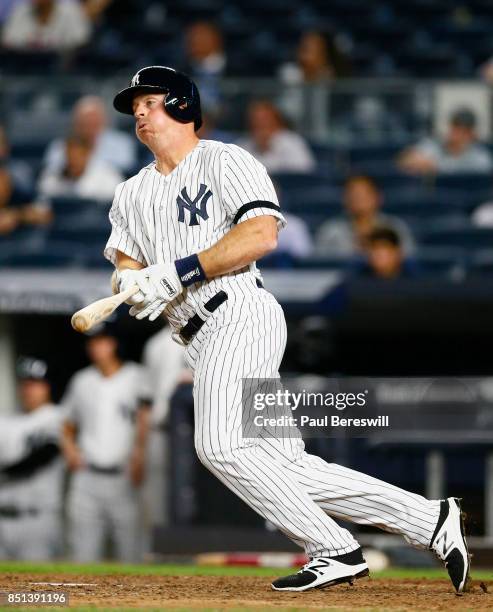 Erik Kratz of the New York Yankees singles in an MLB baseball game against the Baltimore Orioles on September 14, 2017 at Yankee Stadium in the Bronx...