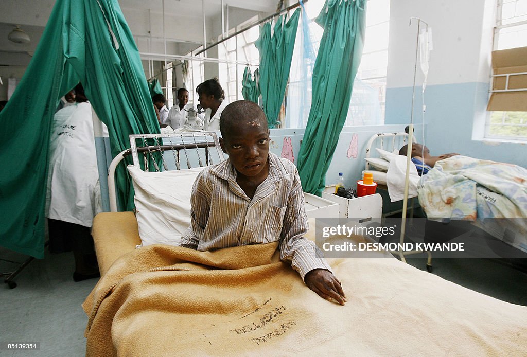 A Zimbabwean cholera patient sits in his