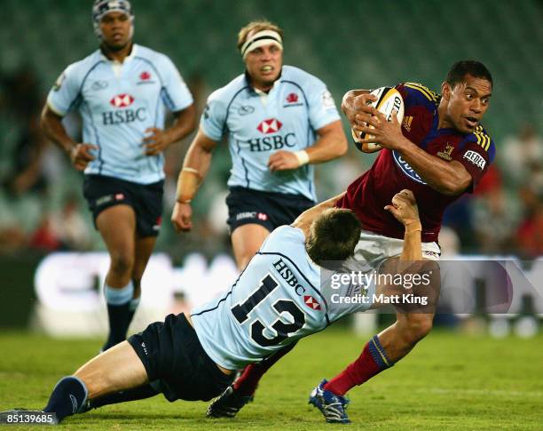 Alando Soakai of the Highlanders is tackled by Rob Horne of the Waratahs during the round three Super 14 match between the Waratahs and the...