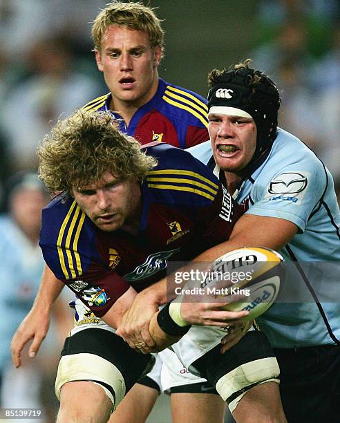 Adam Thomson of the Highlanders is tackled by Will Caldwell of the Waratahs during the round three Super 14 match between the Waratahs and the...