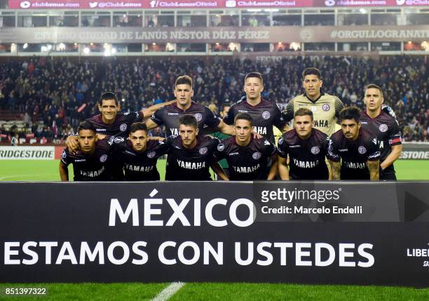 Players of Lanus pose for a photo with a sign that reads "Mexico we are with you" prior to the first during the second leg match between Lanus and...