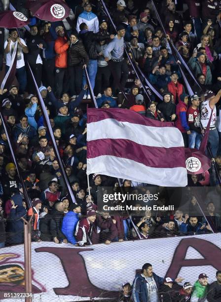 Fans of Lanus cheer for their team during the second leg match between Lanus and San Lorenzo as part of the quarter finals of Copa Conmebol...