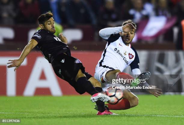 Lautaro Acosta of Lanus fights for ball with Fernando Belluschi of San Lorenzo during the second leg match between Lanus and San Lorenzo as part of...