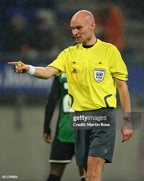 Referee Tony Chapron gestures during the UEFA Cup Round of 32 second leg match between Hamburger SV and NEC Nijmegen at the HSH Nordbank Arena on...