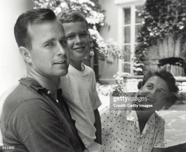 George W. Bush poses with father George Bush and his mother Barbara Bush in Rye, New York, summer 1955. George W. Bush is currently campaigning for...