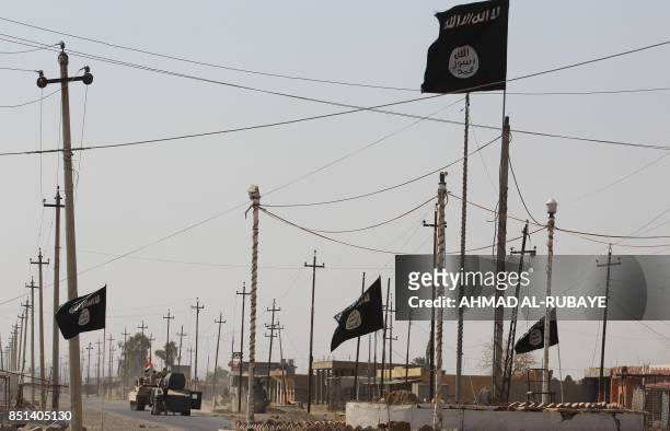 General view shows Islamic State group flags in the northern Iraqi town of Sharqat on September 22 after Iraqi forces ousted the jihadists from the...
