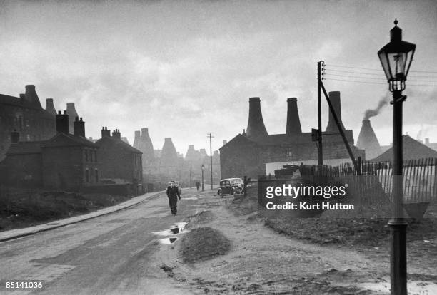 Street in Stoke-on-Trent, Staffordshire, with bottle kilns belonging to potteries visible in the background, 2nd March 1946. Original publication:...