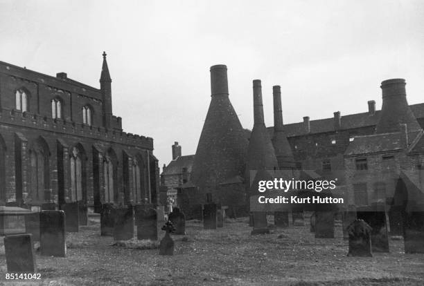 Church next to a pottery with its distinctive bottle kilns, Stoke-on-Trent, Staffordshire, 2nd March 1946. Original publication: Picture Post - 3088...