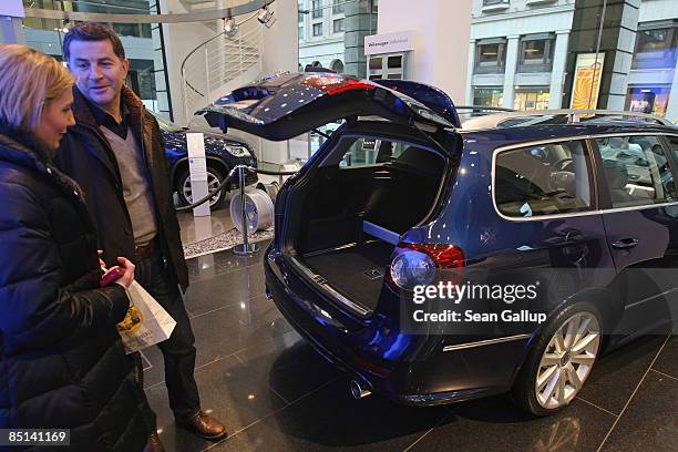 People look at a new Volkswagen Golf Combi car at the Auto Forum VW display rooms on February 27, 2009 in Berlin, Germany. Volkswagen announced that,...