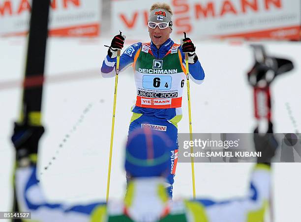 Finland's Ville Nousiainen celebrates with his teammates in the finish area in the men's 4x10 km Classic and Free relay race competition at the...