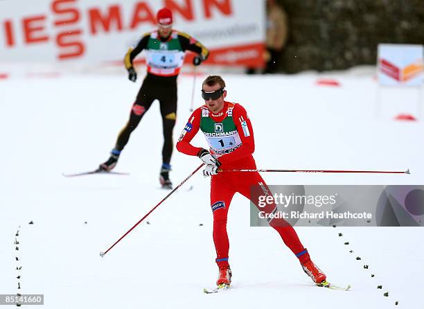 Petter Northug of Norway starts to celebrate as he crosses the line ahead of Axel Teichmann of Germany to win the gold medal during the Men's Cross...