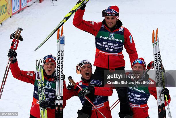 The Norwegen team of Eldar Roenning, Odd-Bjoern Hjelmeset, Tore Ruud Hofstad and Petter Northug celebrate winning the gold medal during the Men's...