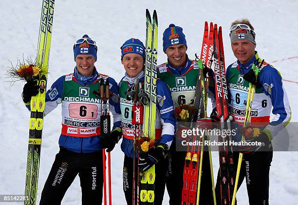 Matti Heikkinen, Sami Jauhojaervi, Teemu Kattilakoski and Ville Nousiainen of Finland celebrate winning the bronze medal during the Men's Cross...